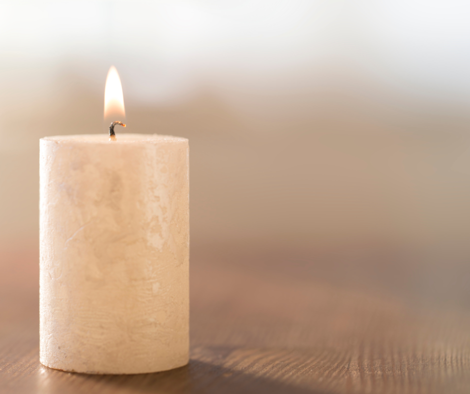 A lit candle on a table