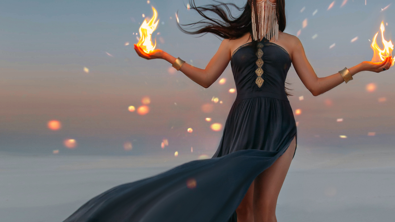 woman holding flames to represent passion of the dark feminine